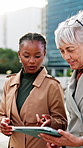 Tablet, team and businesswomen in city for discussion, real estate listing or development report on walk. Tech, people and planning outdoor for proposal, property price review and morning commute