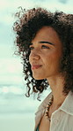 Woman, thinking and summer holiday by beach with smile, relax and reflection for tourist getaway. Happy, female person and outdoor by ocean with good mood, wellness and remember vacation memories.