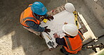 Architect, discussion and men with blueprint on construction site, teamwork and planning for design. Civil engineering, above and people with paperwork for property development and collaboration