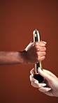 Sensual, toy and hands of people giving in studio for pleasure, personal intimacy or stimulation. Share, couple and women with accessory for sex education, wellness and self love on red background