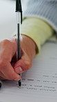 Teacher, hands and marking in office for exam, school and university test or quiz grading. Woman, writing and book or question paper for student, project and college education with assignment or note