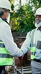 Engineer, men and handshake at site for construction, excavation collaboration or greeting with team. Contractor, happy people and shaking hands outdoor for development partnership, welcome or talk