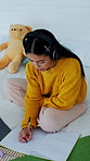 Headphones, student and writing with laptop in bedroom for education, online learning and research. Girl, home and digital tech with notebook for university lecture, information and assignment
