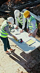 Architect, above and people outdoor at construction site with blueprint, building and excavation. Planning, men and woman together for teamwork, collaboration and civil engineering project or deal