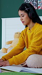 Headphones, student and typing with laptop in bedroom for education, online learning and research. Girl, home and digital tech with notebook for university lecture, writing information and assignment
