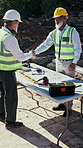 Architect, handshake and men outdoor at construction site with blueprint, building and excavation. Planning, people and shaking hands for teamwork, collaboration and civil engineering project or deal