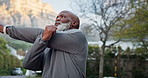 Senior, fitness and black man stretching in street for outdoor workout preparation or exercise. Elderly, active or male person getting ready with arm warm up on road for training, health or wellness