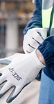Hands, gloves and person on construction site for engineer, architecture or PPE for renovation. Inspector, protective gear and ready for remodeling project, safety compliance or infrastructure review