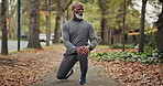Elderly, fitness and black man stretching legs in nature for outdoor exercise or workout preparation. Senior, male person or getting ready with knee warm up for training, health or wellness in park