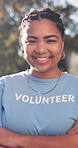 Pride, face or volunteer in park with arms crossed, NGO activist or about us as charity ambassador. Happy, woman or outreach worker with bokeh, humanitarian aid or confidence in social responsibility