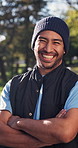 Volunteer, face and man outdoor with arms crossed, NGO activist or about us as charity ambassador. Happy, bokeh or outreach worker with laugh, humanitarian aid or confidence in social responsibility
