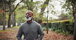 Workout, running and man with headphones at park for health exercise, morning cardio or playlist. Active, mature black person and jogging in nature for fitness, physical activity and music streaming