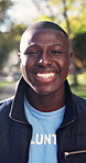 Volunteer, face and black man in park with laugh, NGO activist and about us as charity ambassador. Happy, bokeh and outreach worker with humor, humanitarian aid or confidence in social responsibility