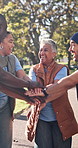 Nature, applause and people with stack of hands for solidarity, support or connection at NGO. Teamwork, collaboration and group of charity workers with celebration for community, bonding or outdoor.