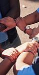 Circle, team and people holding arms for support, solidarity or bonding at nonprofit organization. Collaboration, link and group of volunteers with hands together for connection at NGO from above.