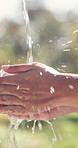 Water, hygiene and person washing hands outdoor for wellness, health or self care in countryside. Sustainability, organic and liquid for cleaning skin for dirt, germs or bacteria removal on farm.
