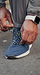 Fitness, hands and tying shoelace on road, wellness and getting ready for physical activity in city. Outdoor, athlete and person with footwear, closeup and preparing for exercise with sneakers
