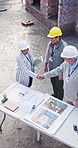 Architect, people or partnership with handshake on construction site for building plan or design. Top view, group or civil engineer team shaking hands for b2b meeting, architecture project or deal