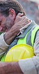Worker, man and neck pain on construction site with injury, building accident and massage for relief. PPE, mature person and hurt outdoor with civil engineering error, muscle sprain and overworked.