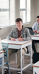 High school, laughing and boy in classroom with joke, funny lesson and happy moment at academy. Participation, youth and teenager with humor, student engagement and good mood in education center.