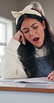 Tired, girl and yawn in exam at high school for sleep deprivation, academic pressure or burnout. Education, student and nap in class test with cognitive fatigue, brain fog and low energy for learning