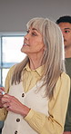 Mature, woman and teacher with whiteboard in classroom for lesson, teaching or education. Female person, tutor or presentation with student for learning, understanding or academic session in school