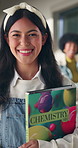 Happy, school and face of girl with books in corridor for learning, education and ready for knowledge. Portrait, student and teenager with chemistry textbook for lesson, course and science at academy
