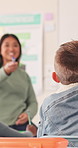 Education, child and answer teacher in class for lesson interaction, critical thinking or learning. Student, educator and asking questions at school for curriculum quiz, problem solving and teaching