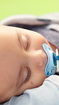 Sleeping, kiss and baby with mother outdoor for support, love and early childhood development. Care, comfort and infant kid with mom for afternoon nap with dream, safety and bonding in nature.