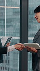 Woman, handshake or business people in office for deal, agreement or introduction together. Female person, employees or shaking hands with technology or documents for b2b or partnership in workplace