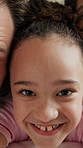 Girl, face and lying with family for selfie, photography or capture moment together in home. Portrait, child or kid smile with parents or guardians for picture, social media or fun childhood in house