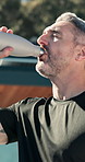 Fitness, outdoor and mature man with water drink on break, rest and exhausted of intense workout. Male person, tired athlete and pause to hydrate for wellness, health and training exercise in summer