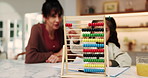 Mother, helping and child in home with abacus, math lesson and counting for education. Mature woman, tutor or kid at house with academic toys, learning support and calculating beads for study session
