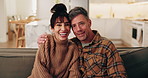 Face, hug and happy couple with love in home for holiday, comfort or bonding together on sofa. Portrait, man and woman relax with smile, care or embrace for weekend, break or rest on couch in house