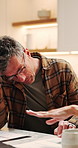 Man, conflict and discussion with documents for financial crisis, debt or over budget in home. Frustrated, male person or fight with stress or paperwork for finance mistake, inflation or bankruptcy
