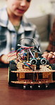 Child, dad and toy car with wires for engineering or remote control vehicle in home together. Boy, kid or learning with father to build robotic transportation for junior mechanic or development