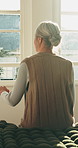 Thinking, back or old woman in house with walking stick, daydreaming or nostalgia in calm mindset. Reflection, window or senior person with disability, flashback or peaceful perspective in retirement