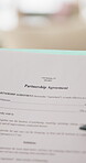 Person, hands and document with partnership agreement for legal contract, policy form or deal. Paper, partner or binding application for shared responsibility, investment or development together