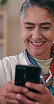 Mature, woman and laugh in home with phone, funny text message response and social media notification. Happy, person and typing in lounge with tech, humor and online meme from digital communication.