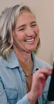 Mature, woman and laugh in home with tablet, funny social media notification and reading digital news. Happy, person and scroll in lounge with tech, humor and online meme from browsing blog website.