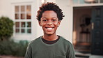 Face, child and smile outdoor at new house, property purchase and relocation at front yard. Portrait, happy and black kid for loan approval, residential lease and moving in for real estate investment