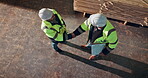 Men, handshake and clipboard on worksite for timber, lumber distribution and collaboration with agreement. Above, woodworking and people at factory with contract, project management and shaking hands