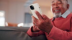 Laugh, phone and hands on couch with text, online communication and comic post in retirement. Happy, space and senior man in house with tech, funny message or meme reaction on social media app.