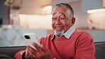 Laugh, phone and old man on sofa with texting, online communication and comic post on social media. Happy, scroll and senior person in house with tech, funny message or meme reaction on digital app.