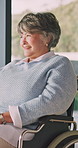 Smile, thinking and senior woman in wheelchair at house for relax, rehabilitation or planning. Happy, window and elderly person with disability in home for reflection, nostalgia or memory in recovery