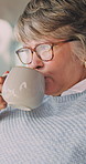 Senior, thinking and happy woman with coffee in retirement home for warm beverage or comfort. Thoughtful, elderly or female person with glasses, cup or mug for caffeine or morning drink in house