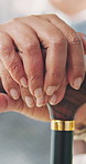 Elderly, woman and hands with cane in house for retirement, mobility support or balance. Closeup, female person or senior with walking stick for rehabilitation, parkinson or help in nursing home