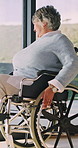 Happy, thinking and senior woman in wheelchair at house for relax, rehabilitation or planning. Smile, window and elderly person with disability in home for reflection, nostalgia or memory in recovery