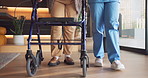 Nurse, legs and patient with walker in retirement house for assistance living, recovery or mobility. Healthcare worker, caregiver or helping person with a disability for elderly care in nursing home