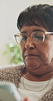 Senior, woman and online in home with tablet, glasses and browsing website for retirement planning. Pensioner, female person and relax in house with tech, research and digital app for life insurance.